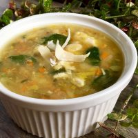 Turkey soup with white beans and spinach, topped with shaved parmesan cheese.